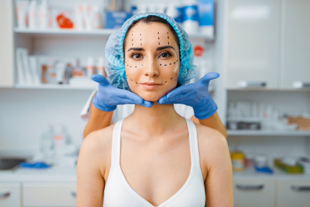Cosmetician and female patient with markers on her face. Rejuvenation procedure in beautician salon. Cosmetic surgery against wrinkles, preparation to botox