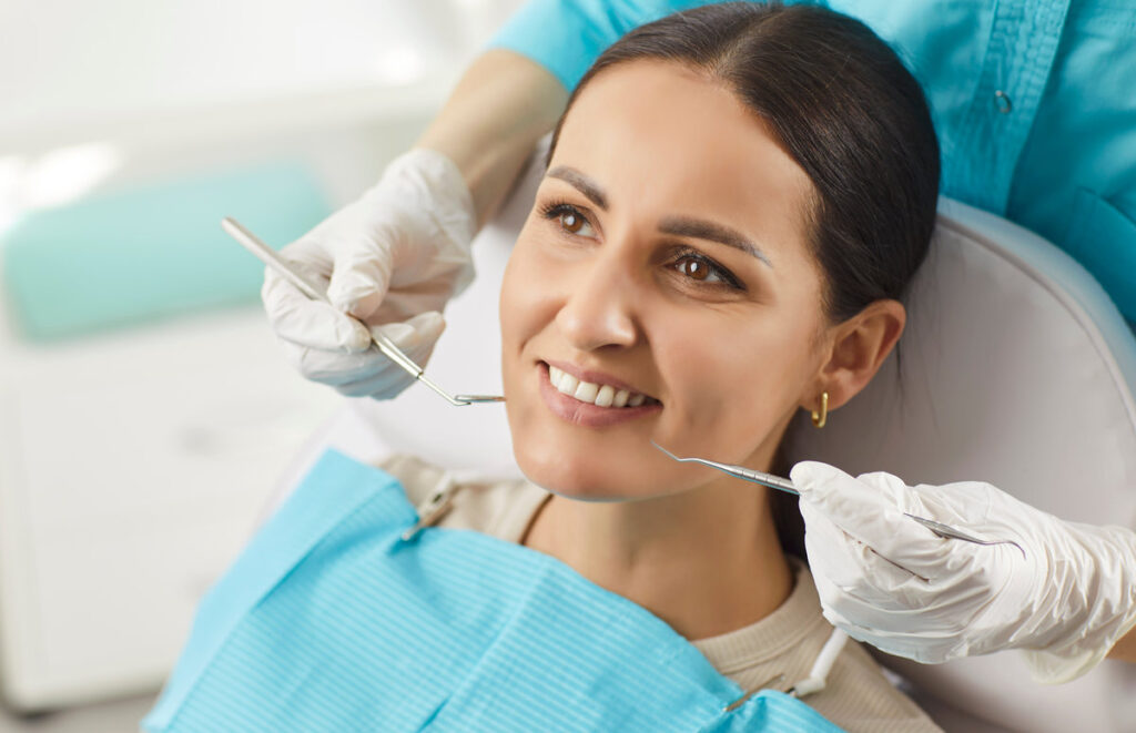 Stomatology clinic, perfect white toothy smile, whitening treatment procedure result in health dentistry service, oralcare, dentist doctor working with happy female patient in medical dental chair